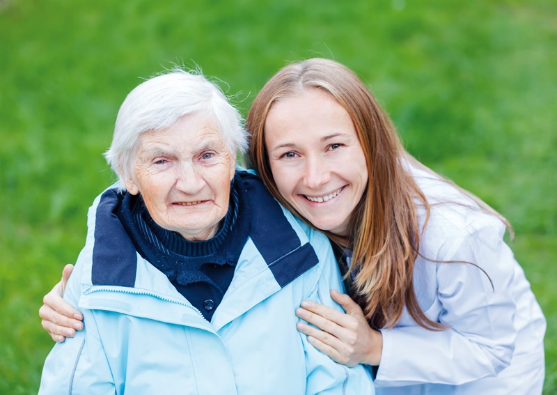 An older woman is embraced by a younger woman