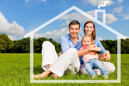 A young family with a small child sits in a house symbolized by lines on a meadow